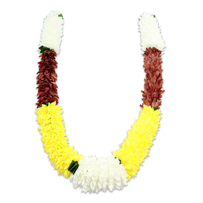 A U-shaped ceremonial garland is shown against a clean white backdrop, its form and colours rendered with quiet dignity. Each symmetrical arm opens with a compact segment of pristine white, chrysanthemum-like fabric blooms-tiny layered petals gathered so closely they read as soft, cloudlike cushions at the top. These white crowns yield to a narrower band of deep maroon or reddish-brown, a rich, earthen tone that anchors the upper curve in shadowed warmth. Below the maroon, the composition swells into a long, luminous stretch of yellow: a field of tightly packed, marigold-like petals that create the garland's generous lower sweep. Where the two yellow lengths meet at the base, a larger cluster of white flowers forms the focal knot, broader and fuller than the end caps, balanced by small dark-green leaf accents that punctuate the color transitions with a natural contrast. The garland's surface is densely textured-thousands of fabric petals layered and stitched to imitate living blossoms-so that light plays across the piece in soft highlights and muted shadows, suggesting volume and hand-crafted precision. The overall impression is one of tradition and celebration; the white, yellow and maroon combination embodies purity, prosperity and devotion, respectively, and is commonly seen in South Asian rituals from wedding ceremonies to temple offerings and festival decorations. For locals attending ceremonies around Stevenage's Town Centre or community halls in Shephall, this durable, ceremonial mala offers a visually faithful alternative to fresh blooms while preserving the symbolic colours and reverent presence required for sacred or festive use.