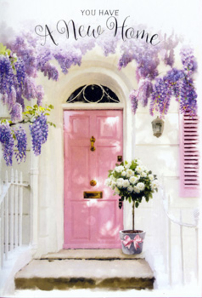 This floral doorway could easily belong to a tucked-away home in Stevenage, lovingly dressed for the excitement of moving day. The central focus is a painted pink door, its pastel tone soft and comforting, with a slightly matte finish that absorbs the light rather than reflecting it harshly. To one side, a matching shutter repeats the same blush shade, tying the entrance together in a cohesive, charming palette. Surrounding them, whitewashed walls lend a clean, bright backdrop, echoing the neat terraces found off the High Street in Stevenage Old Town. Draped from above, wisteria spills in flowing lavender cascades, the elongated clusters composed of tiny petals that appear to flutter even while still. The blossoms hang in layered curtains, some framing the top of the doorway, others tumbling alongside, introducing texture and a romantic, fragrant presence. At the base of the scene, positioned neatly on the step, is a grey tin bucket brimming with flowers. It is filled with white and soft cream roses, their petals delicately curled and densely layered, giving each bloom a plush, cushion-like quality. Sprigs of fresh greenery weave between the roses, adding contrast and suggesting they have been arranged by a careful, skilled hand. A pale pink satin ribbon encircles the bucket and falls in loose tails, catching the light and gently echoing the shade of the door. The overall atmosphere is serene but full of promise, like the quiet pause just before friends arrive with housewarming gifts. One can easily imagine this as the perfect sending image for a New Home card or a same-day flower delivery in Stevenage, conveying a sense of welcome, tenderness, and the start of a beautiful new chapter inside.