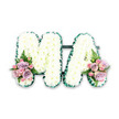 A dignified floral letter tribute spelling MA is captured against a simple white background, allowing its thoughtful structure and soft colours to speak clearly. Both letters are formed on a hidden frame and entirely clad in white chrysanthemums, each bloom carefully positioned so that their petals overlap in a seamless, cushion-like layer. The result is a smooth, plush surface of white, subtly varied by the tiny greenish centres of some flowers, which bring a hint of depth and life to the design. Around the outside of the M and the A, a deep, emerald green ribbon is neatly pleated into a fine, ruffled edge. This satin border traces every angle and curve of the lettering, giving the tribute crisp definition and a gently luxurious feel. At the lower left side of the M and the lower right of the A, dainty, coordinated flower clusters introduce pastel hues. These accents combine lilac roses, soft blush pink roses, and clusters of pink spray roses, their velvety petals layered and slightly curled. The flowers are gathered closely, forming low mounds of colour that nestle into the white chrysanthemums. Delicate fern fronds emerge gracefully from the sides of each cluster, adding height, natural movement, and an airy touch of greenery. The overall impression is one of calm, affectionate remembrance, suitable for a Stevenage funeral service at the crematorium or a memorial near King George V Playing Fields. The MA letters feel deeply personal-perhaps a final tribute to a beloved mother or Mama-and the combination of pure white and gentle pastels expresses both sorrow and love, holding memories with quiet, enduring grace.