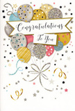 The photograph features a refined congratulations card whose design captures the excitement of a special moment, like sharing achievement news over coffee in Stevenage town centre. The card stands vertically, with a clean, light backdrop that sets off the richly decorated front. A large bouquet of illustrated balloons dominates the composition, rising from the lower half and reaching almost to the top edge. Their shapes are rounded and softly luminous, rendered in muted metallics and pastels: champagne gold, brushed silver, pale sky blue, rosy blush pink, and gentle grey. Each balloon bears its own decorative touch-tiny glittering stars, slim stripes, or confetti-like clusters of dots-adding subtle sparkle and variety without overwhelming the eye. The balloons seem to glimmer as though catching overhead party lights. At their bases, delicate ribbons unfurl, twisting and curling in long, graceful lines of gold and silver ink that feel very much like the curling ribbon used on celebratory bouquets or gift baskets. The surrounding space is animated with tiny stars and swirling motifs scattered across the background, evoking the carefree fall of confetti at the end of a toast or speech. Across the central portion of the card, a gently curved banner stretches from one side to the other, giving the impression that it is being gently lifted by the balloons. On this banner, the words Congratulations To You are written in elegant, looping calligraphy, the strokes smooth and confident, conveying warmth and sincerity. The overall design feels airy yet polished, making this card a natural companion to fresh flowers delivered around Stevenage for milestones such as graduations, work promotions, new homes, or any achievement that deserves to be celebrated with style and genuine joy.